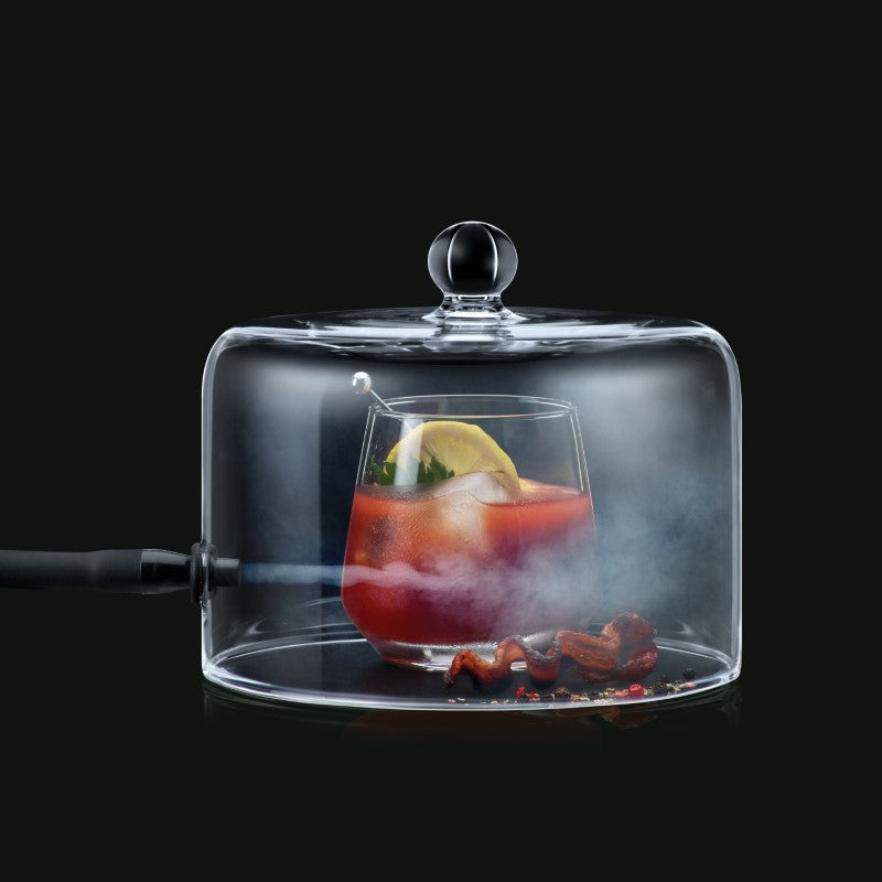 cloche with pipe blowing smoke into a bloody mary